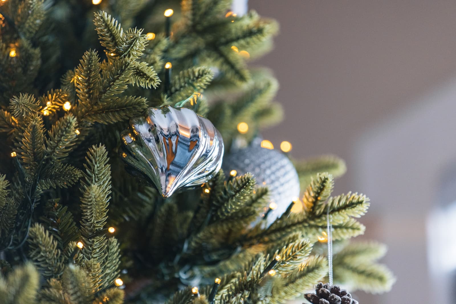 A disassembled artificial Christmas tree with its branch sections laid out on the floor
